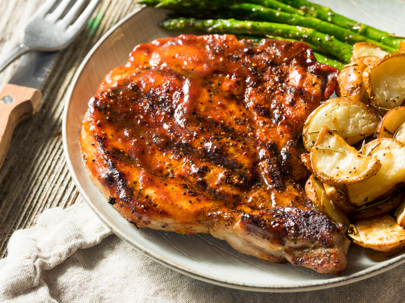Oven baked bone in pork chops with asparagus and roasted potatoes