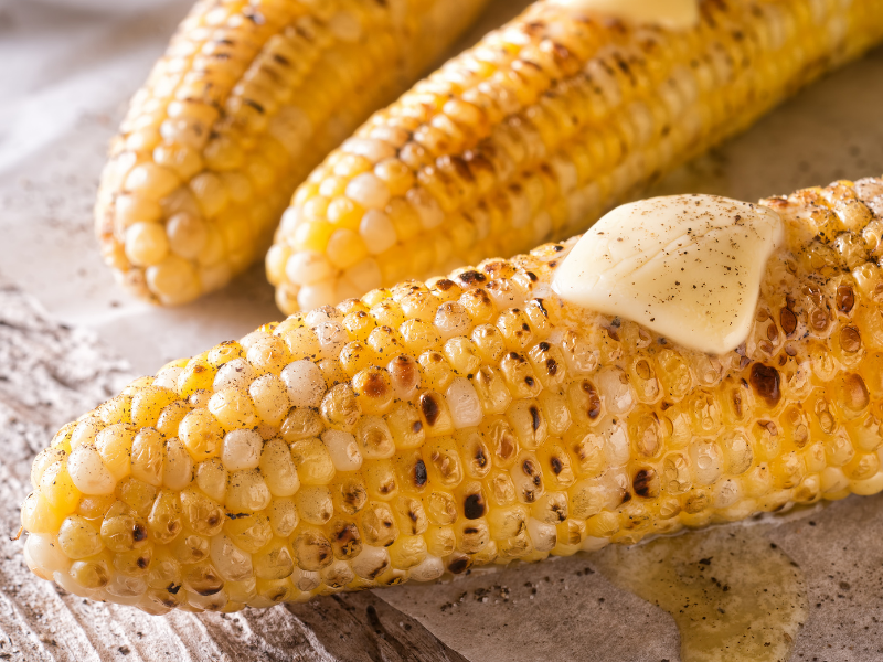 Grilled corn on the cob with pepper and salt