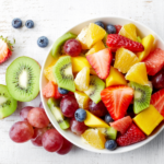 Fresh fruit salad with strawberries, blueberries, oranges, red grapes, kiwis, grapefruits, mangos