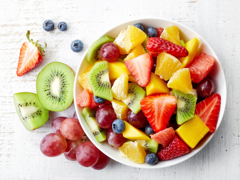 Fresh fruit salad with strawberries, blueberries, oranges, red grapes, kiwis, grapefruits, mangos