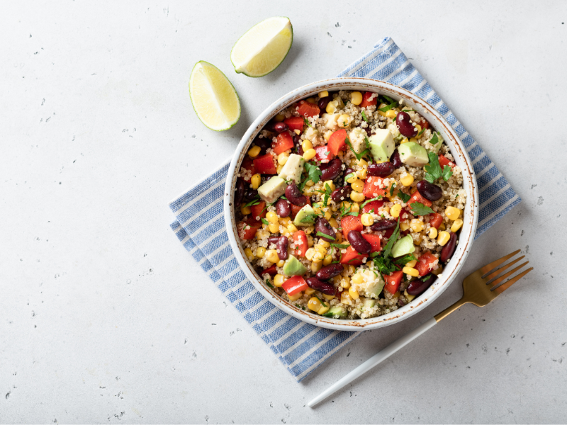 Quinoa kidney bean salad with corn and avocado and tomatoes and lettuce and bell pepper