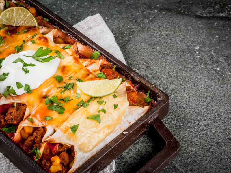 Spicy beef enchiladas with homemade sauce, cheese and sour cream
